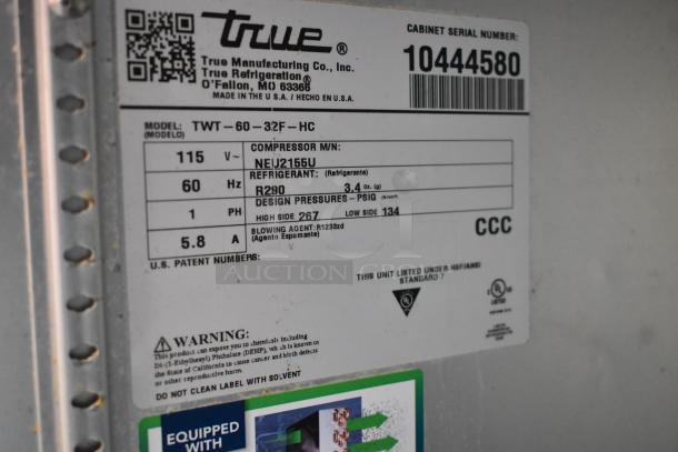Label on a 2023 True TWT-60-32F-HC stainless steel commercial work top freezer, 115V, model and safety info visible.