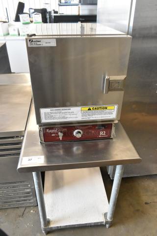 Southbend R2 RapidSteam stainless steel gas steam cabinet, excellent condition, on stainless steel table, caution label visible.