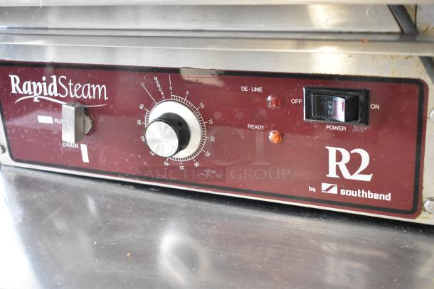 Southbend R2 RapidSteam countertop gas steam cabinet on stainless steel table, well-maintained, control panel visible.
