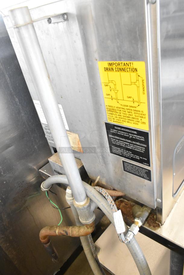 Southbend R2 RapidSteam stainless steel steam cabinet with visible drain connection instructions, mounted on a stainless steel table.