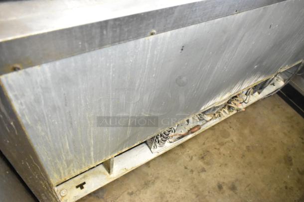 Beverage Air stainless steel 2-door undercounter cooler on casters. 115 volts, 1 phase. Visible wear and wiring underneath.