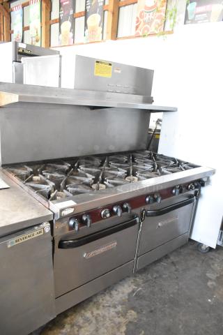 Southbend X460DD stainless steel 10-burner range with 2 ovens, overshelf, and backsplash on casters. Natural gas powered.
