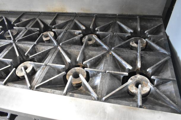 Southbend X460DD 10-burner range, stainless steel, natural gas, with 2 ovens, overshelf, backsplash, on casters, used condition.