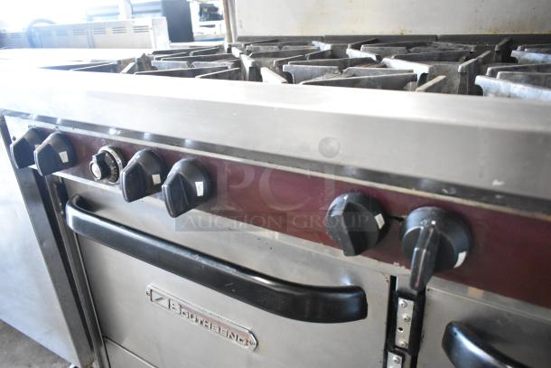 Southbend X460DD stainless steel 10-burner range with double ovens, overshelf, backsplash, and casters. Natural gas.