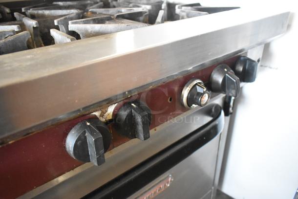 Southbend X460DD stainless steel 10-burner range, natural gas, with 2 ovens. Visible knobs and slight surface wear.