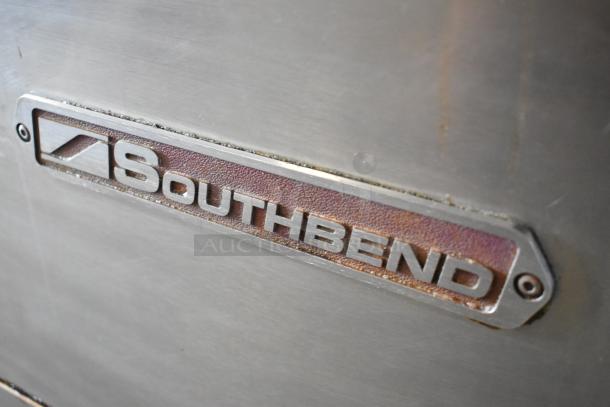 Southbend X460DD stainless steel range, 10 burners, 2 ovens, with overshelf, backsplash, and casters; Southbend logo visible.