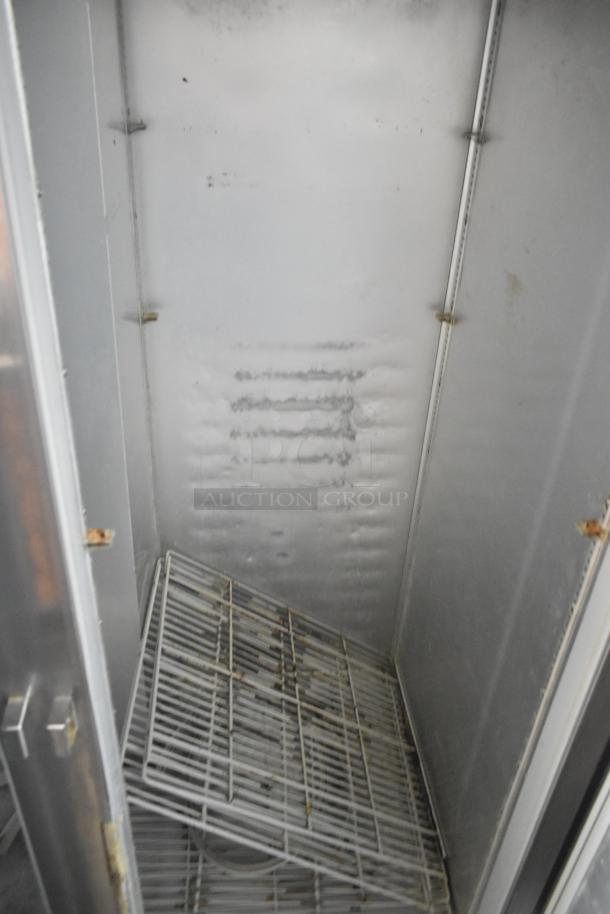 Beverage Air E Series commercial 2-door reach-in cooler, stainless steel, on casters. Left door does not stay closed. Interior shown.