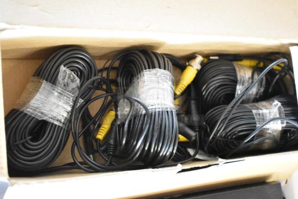 Floureon D2316Y Digital Video Recorder cables, bundled in plastic wrap, showing connectors in a cardboard box.