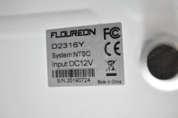 Floureon D2316Y Digital Video Recorder label showing model, system (NTSC), input (DC12V), serial number, and certifications.