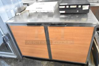 Duke RUF-48M stainless steel commercial 2-door work top cooler, 120 volts, 1 phase. Features wood panel doors.