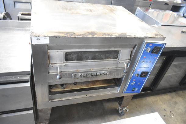 Bakers Pride EP-2-2828 SuperDeck pizza oven; stainless steel, 2 decks, on metal legs with casters; lower door detached; 208V, 1 phase.