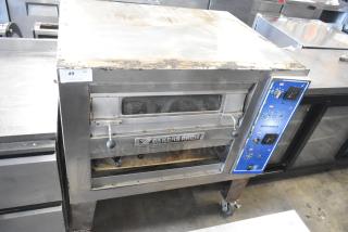 2017 Bakers Pride EP-2-2828 SuperDeck Stainless Steel Commercial 2 Deck Pizza Oven on Metal Legs and Commercial Casters. Lower Door Needs to be Reattached. 208 Volts, 1 Phase. - Item #1199299