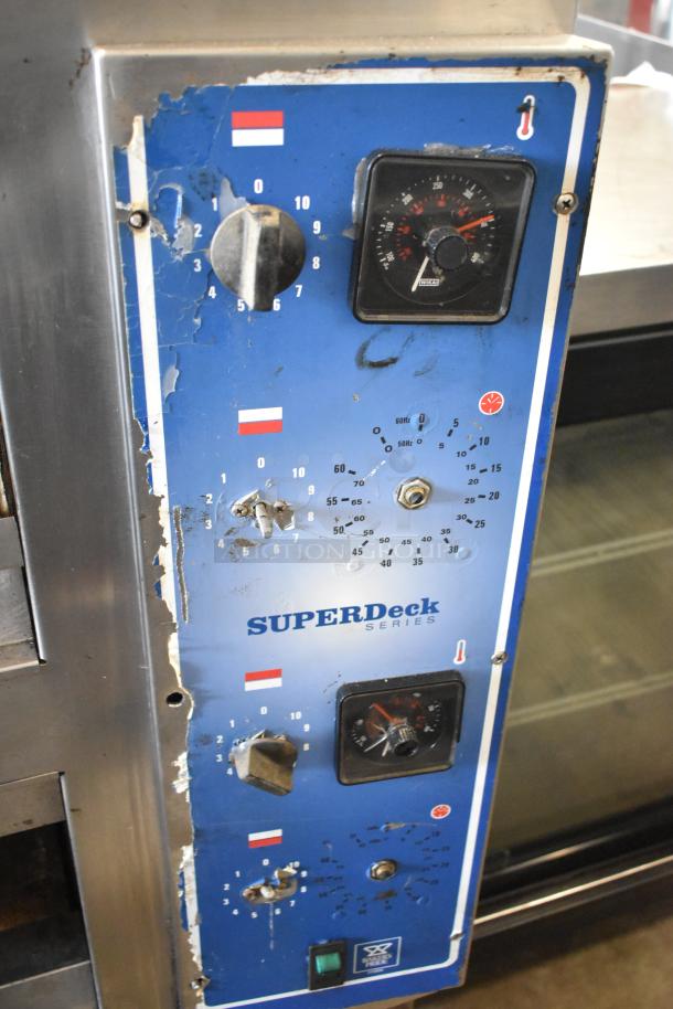 Bakers Pride EP-2-2828 SuperDeck 2 deck pizza oven, stainless steel, on metal legs. Lower door needs reattachment. 208V, 1 phase.