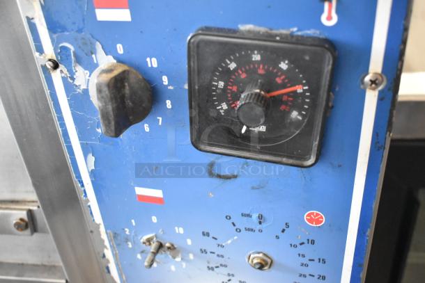 Bakers Pride EP-2-2828 pizza oven control panel, blue with wear, shows temperature dial. Lower door needs repair.
