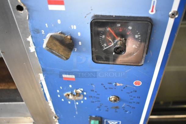 Bakers Pride EP-2-2828 SuperDeck pizza oven controls. Features a worn blue surface with dials and labels.