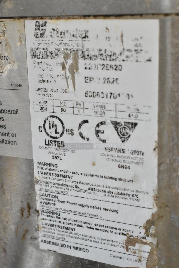 Bakers Pride EP-2-2828 label details with warnings and specifications, including voltage and certifications, visible on rusted stainless steel.
