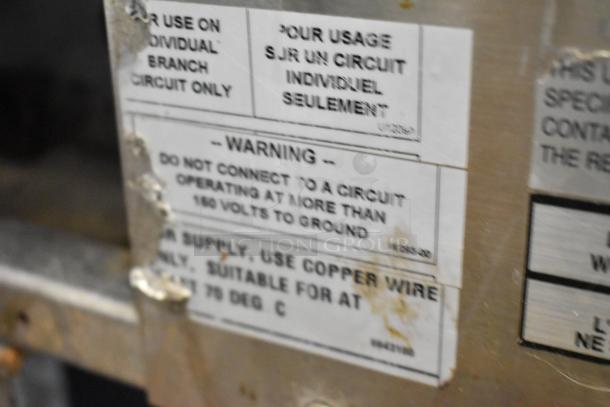 Warning labels on Bakers Pride EP-2-2828 SuperDeck pizza oven. Notice: Connect below 160 volts to ground.