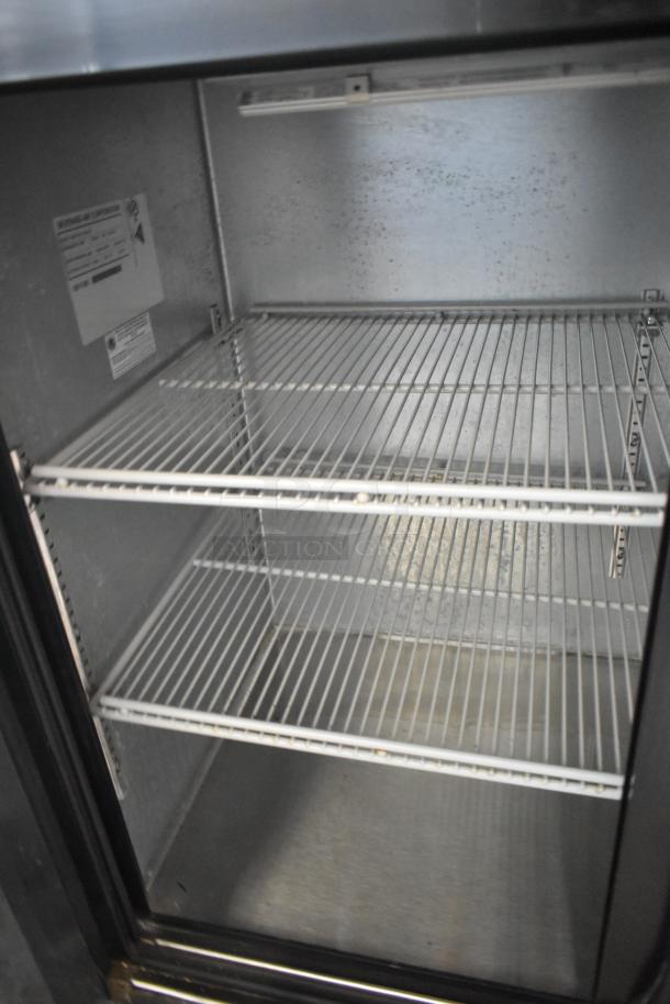 Beverage Air BB72HC-1-GS-B-27 commercial 3-door back bar cooler, metal interior, 115 volts, shelves visible, label on side.