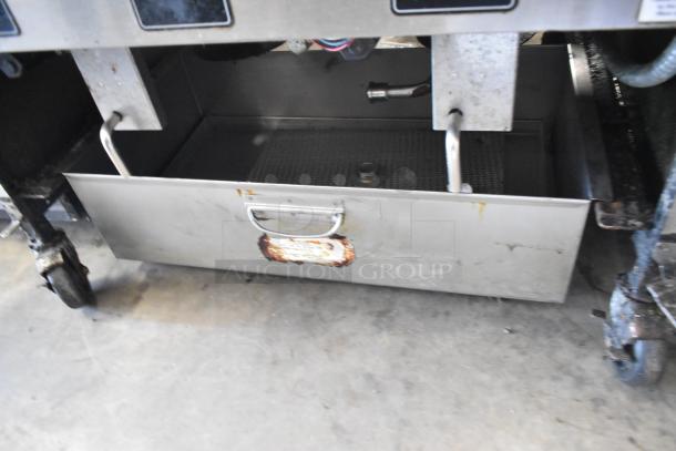 2019 Henny Penny OFG-322 deep fat fryer, stainless steel, 2 bay, natural gas, on commercial casters, some wear visible.