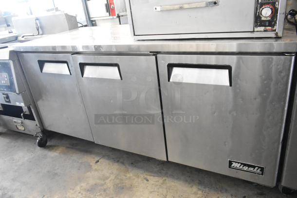 Migali C-U72R stainless steel 3-door undercounter cooler, on commercial casters, 115 volts, shown in good condition.