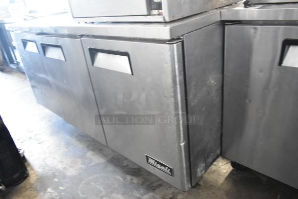 Migali C-U72R stainless steel commercial 3-door undercounter cooler with casters. Operates at 115 volts, 1 phase.