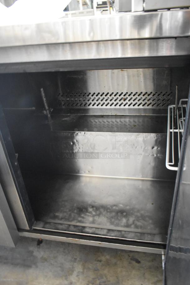 Migali C-U72R stainless steel 3-door undercounter cooler on casters, 115V, 1 phase, commercial-grade, good condition.