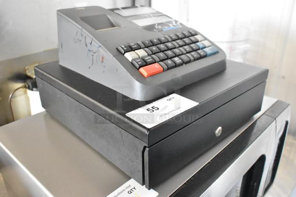 Royal 520DX electronic cash register, 120 volts, countertop model. Visible number pad, slight surface markings. Auction label included.