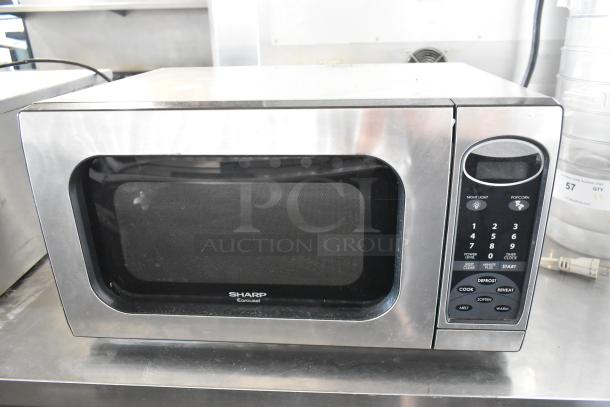 Sharp R-405KS-T countertop microwave oven, stainless steel, 120 volts, 1 phase, visible keypad, includes plate.