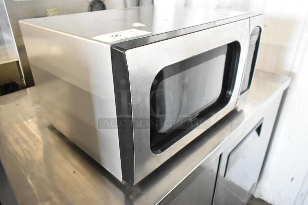 Sharp R-405KS-T countertop microwave oven with plate, stainless steel, 120 Volts, 1 Phase. Shows slight surface wear.