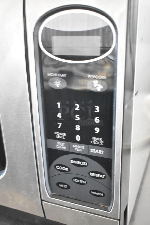 Sharp R-405KS-T countertop microwave oven control panel, featuring buttons for cooking, defrosting, reheating, and timer settings.