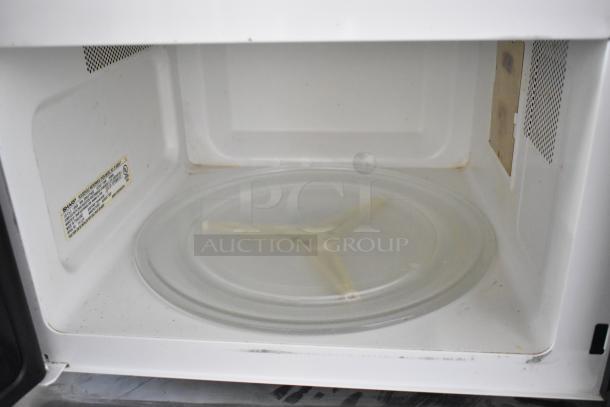 Sharp R-405KS-T countertop microwave, inside view with glass plate and label visible, good condition, 120V, 1 Phase.
