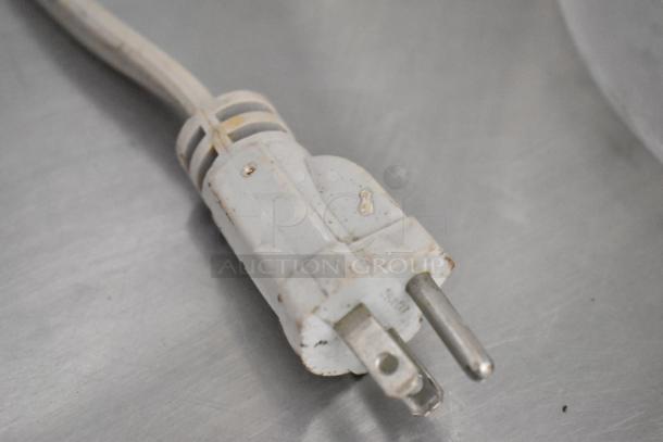 Close-up of a power plug connected to a Sharp R-405KS-T countertop microwave oven. 120 volts, 1 phase.