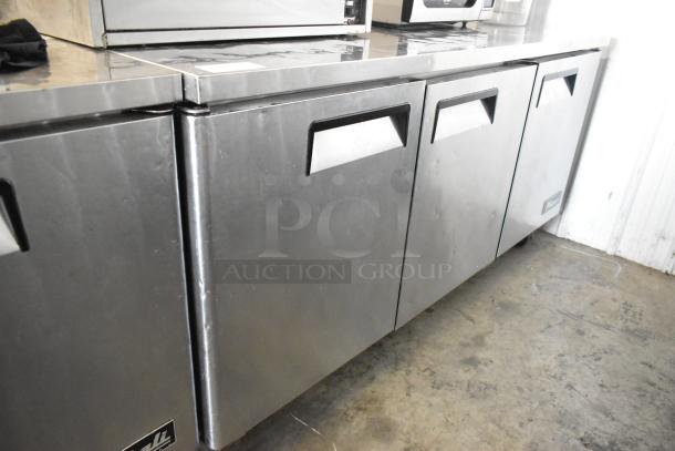 Migali C-U72R stainless steel 3-door undercounter cooler with commercial casters. 115 volts, 1 phase.