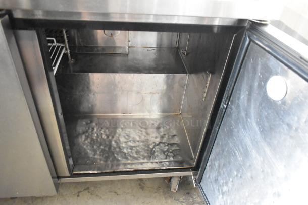 Migali C-U72R stainless steel 3-door undercounter cooler, open door view, commercial casters; used condition.