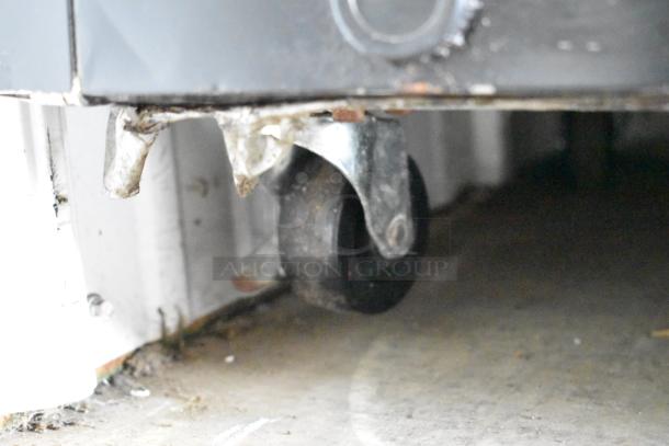 Arctic Air AUB65RZ cooler caster wheel, metal, on commercial casters; part of commercial back bar bottle cooler.