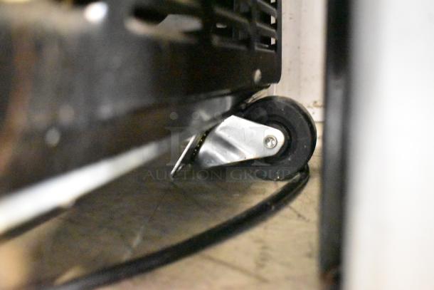 Close-up of a caster wheel on the Arctic Air AUB65RZ commercial back bar bottle cooler, highlighting mobility.
