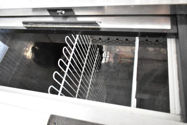 Arctic Air AUB65RZ commercial back bar cooler with 2 sliding lids, metal finish, wire shelving, on casters. 115 volts, 1 phase.