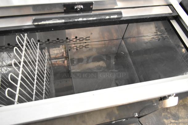 Arctic Air AUB65RZ metal back bar cooler with 2 sliding lids, commercial casters; 115V, 1 phase. Interior view.