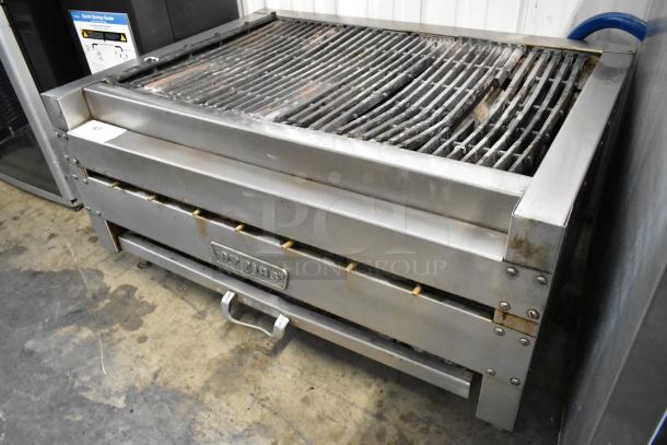 Attias stainless steel countertop gas charbroiler grill, used condition with visible wear; prominent brand logo on front.