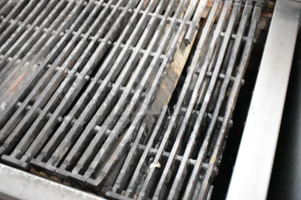 Attias stainless steel commercial countertop gas charbroiler grill, showing close-up of grill surface, in used condition.