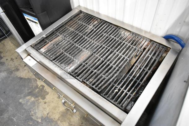 Attias stainless steel commercial countertop gas charbroiler grill with visible grates; shows signs of use.