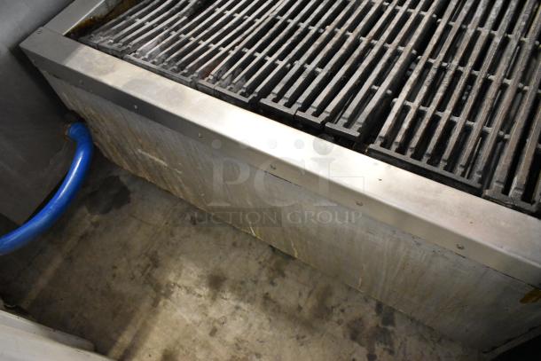 Attias stainless steel commercial countertop gas charbroiler grill, heavy-duty grates, used condition, blue gas hose attached.
