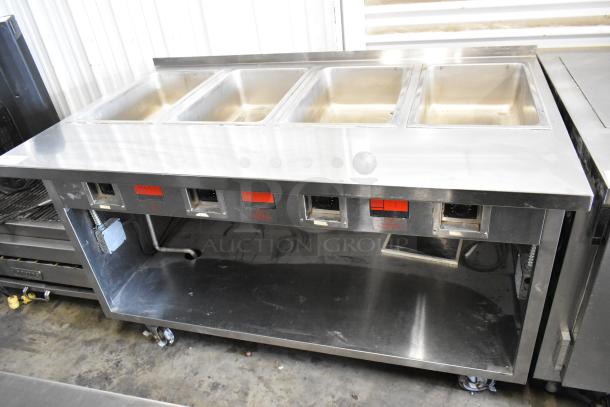 Standex TM-90D stainless steel 4-bay steam table, electric-powered, with under shelf on casters, 208V, 1 phase.