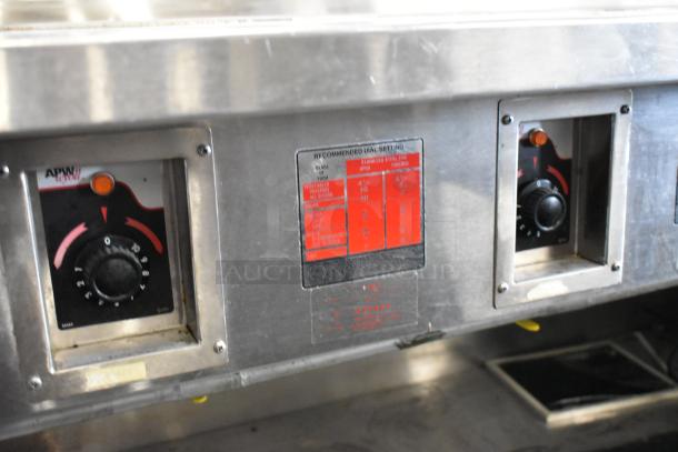 Standex TM-90D stainless steel 4-bay steam table. Features electric controls, under shelf, and commercial casters.