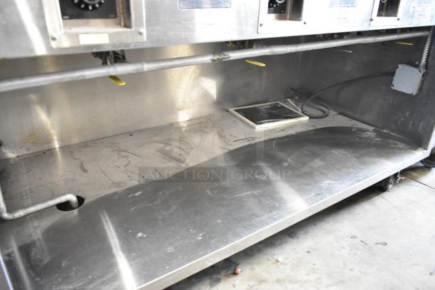 Standex TM-90D stainless steel steam table, 4 bay, under shelf, commercial casters, 208V 1 Phase, good condition.