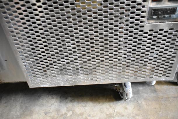 Stainless steel commercial prep table, 2 doors, on commercial casters. 115V, 1 phase. Durable and mobile; perfect for kitchens.