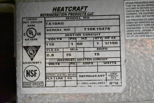Stainless steel commercial prep table with 2 doors, 115 volts, 1 phase, Heatcraft refrigeration label.