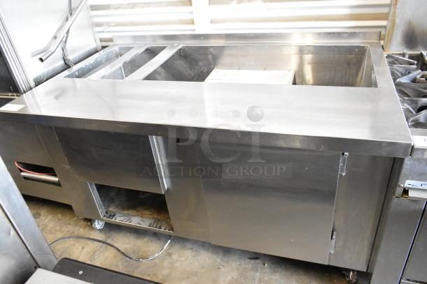 Universal Coolers stainless steel commercial prep table with casters, 115 volts, 1 phase, excellent condition.