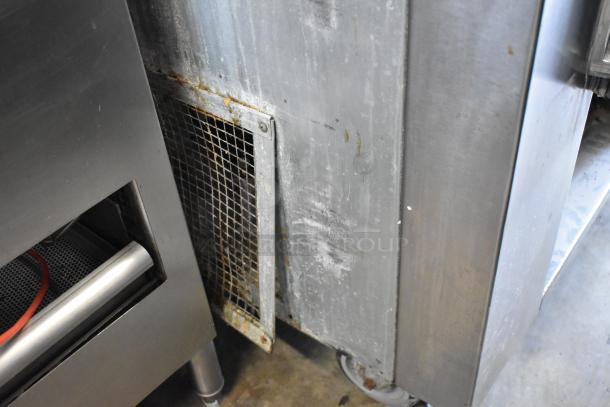 Universal Coolers stainless steel commercial prep table with casters, 115 volts, 1 phase. Used condition with visible wear.