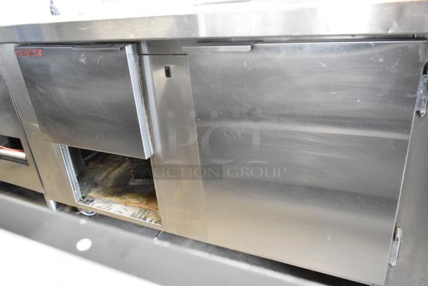Universal Coolers stainless steel commercial prep table on casters, 115V, 1 phase, minor surface wear, durable design.